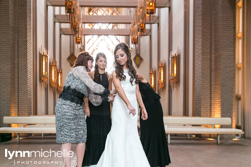 bride getting dress at fort worth wedding chapel