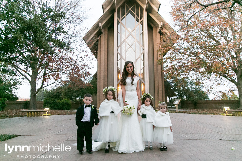 bride with flower girls and ring bearers wearing black and white