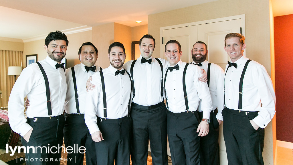 groom and groomsmen in black bowtie and suspenders